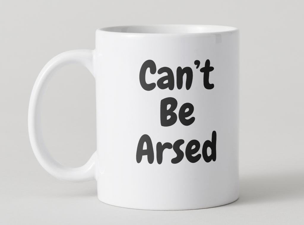 White mug with 'Can't Be Arsed' text on a light gray background