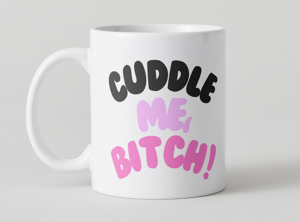 White mug with black and pink text on a light gray background