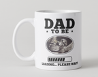 White mug with 'Dad to Be' and ultrasound graphic on a light gray background