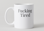 White mug with 'Fucking Tired' text on a light gray background