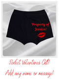 Black shorts with 'Property of Jessica!' text and red lip print on a white background