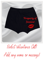 Black shorts with 'Property of Jessica!' text and red lip print on a white background